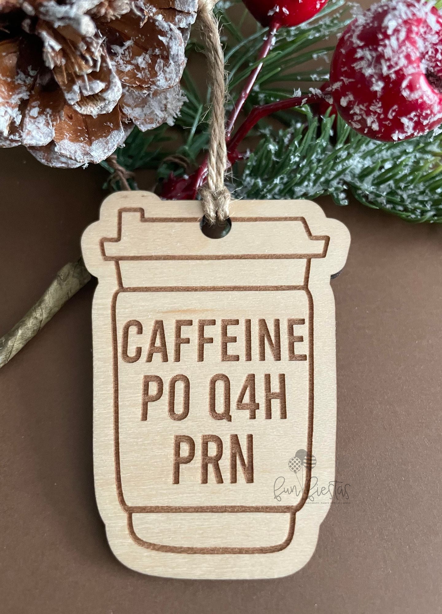 Nurse-themed Christmas ornament in the shape of a coffee cup, engraved with the phrase 'Caffeine PO Q4H PRN'