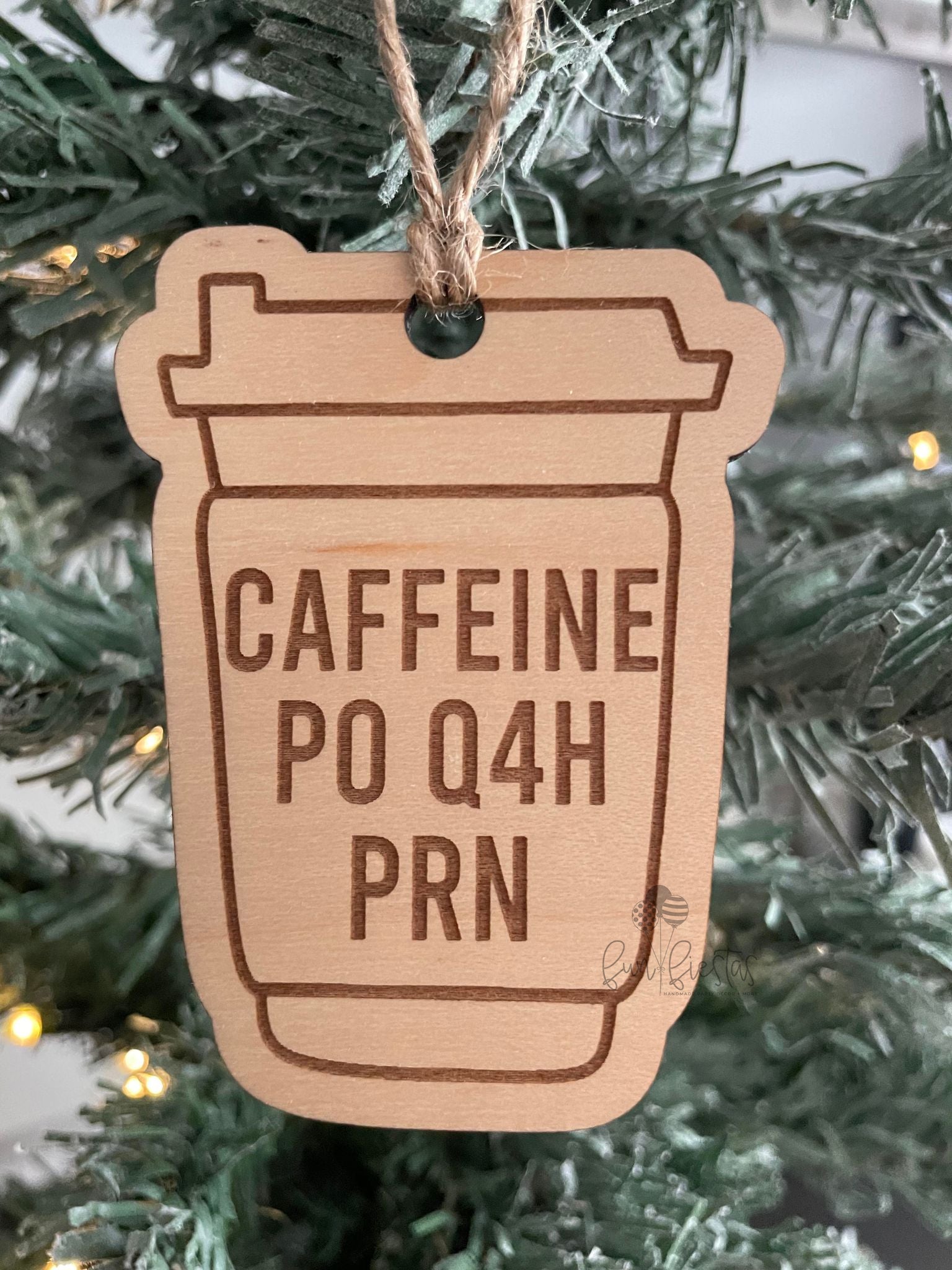 Nurse-themed Christmas ornament in the shape of a coffee cup, engraved with the phrase 'Caffeine PO Q4H PRN'